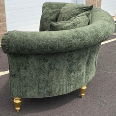 a green chair sitting on top of a parking lot