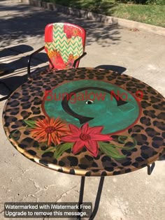 an animal print table and chair sitting on the sidewalk