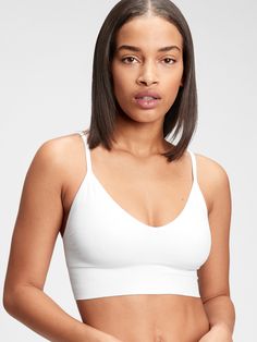 Soft, seamless knit.  Plunge neckline.  Adjustable straps. Gap Fitted Seamless Bra, Seamless V-neck Bra For Yoga, Seamless V-neck Yoga Bra, Yoga Seamless V-neck Bra, Compressive White Bra, White Compressive Bra, White Compressive Fit Bra, Seamless Fabric Bra With Built-in Support, Seamless Fabric Sports Bra With Built-in Bra