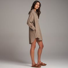 The Merritt has an easy, flowing drape and can be worn as loose top layer, a duster, or on its own as a dress. Made from luxe Tencel, a plant-based, eco-friendly fiber produced with with low amounts of water and a low carbon footprint. It is durable yet ultra-soft with an easy drape. The asymmetrical set-in and patch front pockets and double stitch reinforced placket and hem speak to classic utility with a modern, casual elegance. The double stitch reinforced inverted back pleat with triangle ta Oversized Tunic For Spring Daywear, Oversized Spring Tunic For Daywear, Casual Fall Dress With Unlined Sleeves, Fall Day Out Tunic, Chic Button-up Tunic For Spring, Chic Spring Button-up Tunic, Spring Daywear Dress With Shirttail Hem, Fall Long Sleeve Daywear Tunic, Relaxed Fit Tunic For Fall Daywear