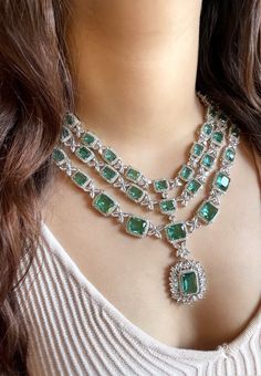 Add a touch of glamour and sophistication with this high quality necklace set in beautiful Teal green stones. The stones in this set bling and look close to the real thing. This set is sure to make heads turn!  It features an adjustable necklace and a pair of earrings. It can be paired perfectly with both ethnic and western outfits.  In case of any queries, please feel free to reach out. Happy shopping! Item includes Necklace and earrings Hand Set Crystal Emerald Necklace For Wedding, Cubic Zirconia Emerald Necklace For Wedding, Wedding Emerald Crystal Necklace Hand Set, Hand-set Cubic Zirconia Emerald Necklace For Wedding, Exquisite Cubic Zirconia Emerald Necklace For Wedding, Elegant Emerald Necklace With Stone Work For Wedding, Green Bridal Necklace With American Diamonds, Emerald Jewel Bridal Necklace For Wedding, Green American Diamond Bridal Necklace For Wedding