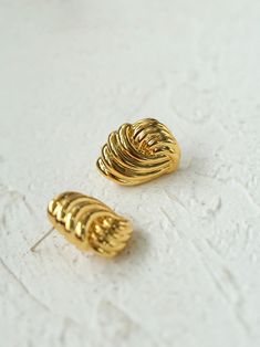 The Spiral Metallic Stripe Geometric Earrings feature a unique design where the metal pattern swirls around to create a dynamic and modern feel. These earrings combine geometric shapes with an artistic flair, making them a striking accessory for both casual and formal occasions. Perfect for those who appreciate modern style. Metal: 18K Recycled Gold Plated On Brass/Recycled Sterling Silver Plated On Brass/ 925 Sterling Silver Ear Needle Earrings Dimensions: Length 20mm Single Earring Weight: 5g Modern Spiral Metal Jewelry, Hypoallergenic Spiral Metal Earrings, Spiral Single Brass Earring, Spiral-shaped Pierced Metal Jewelry, Silver Spiral Brass Earrings, Needle Earrings, Edison Pearls, Tiger Eye Stone, Metal Earrings