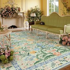 a living room filled with furniture and flowers on the floor next to a fire place