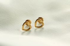 Open heart-shaped earrings, handmade with 18k yellow gold. Simplicity at its best, these classic studs are light enough to wear comfortably, but solid -- made with real, 18k gold -- a quality generally reserved for more expensive pieces. If you have a question, please send a message ... I'm always happy to help! These earrings were handcrafted with love in Los Angeles, California. Elegant Heart Detail Earrings For Gift, Elegant Earrings With Heart Detail, Elegant Everyday Earrings For Valentine's Day, Elegant Heart Shaped Everyday Earrings, Elegant Heart-shaped Everyday Earrings, Elegant Everyday Heart Shaped Earrings, Elegant Open Heart Earrings For Everyday, Elegant 14k Gold Heart Earrings Tarnish Resistant, Elegant 14k Gold Tarnish-resistant Heart Earrings