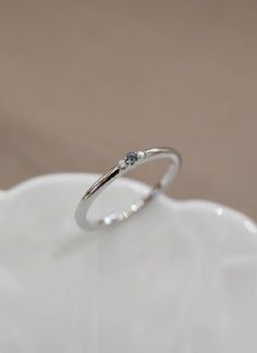 14k white gold | 1.7mm round birth stone accented band Olive Avenue, Olive Avenue Jewelry, Baguette Diamond Rings, Blue Zircon, Engraved Items, Jewelry Companies, Baguette Diamond, Moissanite Rings, Perfect Ring