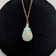 No stone is more mythical or enchanting than the opal. This necklace is a great way to get a clean and modern look while honoring a beautiful stone and style. We showcase this unique and captivating stone in a handcrafted setting, topped with a sparkling diamond. Available in 14k yellow gold Features a natural 13mm x 9mm opal, approx. 2.50ct Accented by a 2mm natural diamond Pendant measures approx. 16mm x 9mm Hanging from a new 18" 14k chain with secure lobster clasp Formal Opal Teardrop Pendant Jewelry, Formal Teardrop Opal Pendant Jewelry, Pear-shaped Opal Jewelry For Formal Occasions, Formal Opal Pear-shaped Jewelry, Formal Pear-shaped Opal Jewelry, Opal Drop Gemstone Jewelry, Pear-shaped Opal Gemstone Jewelry, Pear-shaped Opal Gemstone Necklace, White Pear-shaped Opal Jewelry