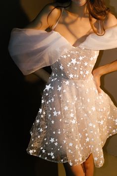 a woman wearing a dress with stars on it