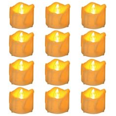 twelve yellow candles with one lit on each side and six in the middle, set against a white background