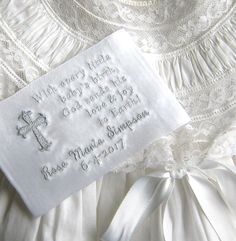 a close up of a white dress with an embroidered name tag on the front and back