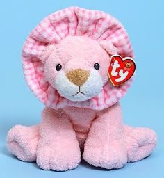 a pink teddy bear with a heart tag on it's ear sitting against a blue background