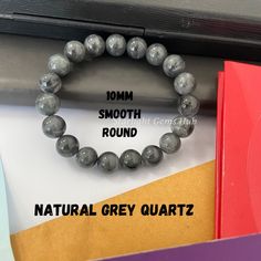 Product Description: Item Code: SGH-29 Stone Name: Grey Quartz Size: 10MM Shape: Smooth Round Color: Grey  Length: Stretchable Weight: 166Cts (Approx.) Lock: 925 Lobster Clasp **All natural gemstones vary in color and pattern. We try our best to make our photos represent the real products in person. ** **All Customization Facility Is Available as per your Requirement Also in Other stones. ** **Bulk Order also available** **Please feel free to contact for any further queries** Gray Gemstones, Grey Quartz, Gray Jewelry, Rose Quartz Bracelet, Unisex Bracelets, She & Him, Quartz Bracelet, Jade Beads, All Natural