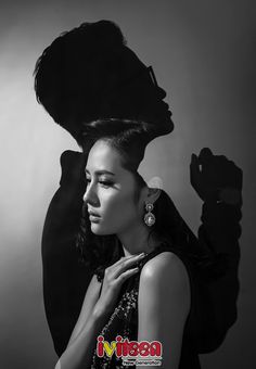 a black and white photo of a woman with her hair in the shape of a hat