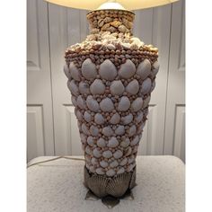 a lamp made out of seashells on a table