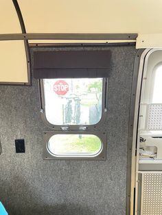 the inside of an rv with a stop sign in the window