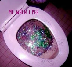 a white toilet covered in lots of glitter next to a trash can with the words me when i pee on it