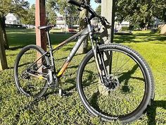 a bike is parked in the grass near a pole