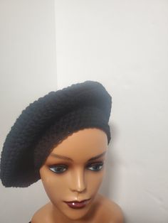 Add some color to your casual outfits with this handmade black crochet beret tam beanie. Made from lightweight and breathable acrylic material, this hat is perfect for all seasons. The beanie features accents of crochet and is adorned with a reggae-themed design that is sure to turn heads. This one-size-fits-all beanie is an ideal addition to your wardrobe if you are a fan of reggae or rastafarian culture. It has stretchy fabric that ensures a comfortable fit and is suitable for both men and women. With no tags attached, this beanie is like new and ready to be worn to any casual occasion. Adjustable Black Crochet Hat Trendy Style, Trendy Adjustable Black Crochet Hat, Trendy Black Adjustable Crochet Hat, Black Acrylic Beanie, Black Acrylic Yarn Beanie Cap, Black Acrylic Yarn Beanie, Casual Black Brimmed Beret, Black One Size Beanie From Acrylic Yarn, Black One Size Beanie In Acrylic Yarn