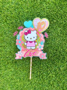 a hello kitty lollipop on the grass