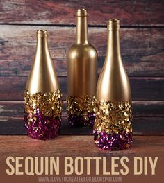 three wine bottles with gold and purple sequins