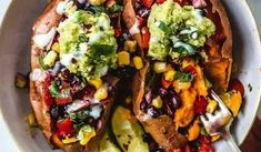 two loaded sweet potatoes with guacamole and salsa