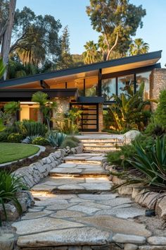 a modern house with stone steps leading up to it