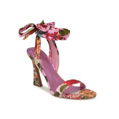 Nine West-Kobs Sandal Exude a summer chic vibe wearing the Kobs sandal from Nine West. Vibrant floral prints highlight this gorgeous sandal set atop a high tapered heel. The unique ankle wrap tie closure ensures a personalized fit while the synthetic footbed keeps your feet relaxed all day. Spring Floral Print Block Heels, Floral Print Block Heel Sandals, Spring Floral Print Block Heel Sandals, Pink Block Heel Sandals For Spring, Floral Print Block Heel Sandals For Party, Floral Print Block Heel Party Sandals, Summer Floral Print Block Heel Sandals, Multicolor Tropical Sandals For Spring, Feminine Pink Sandals For Spring