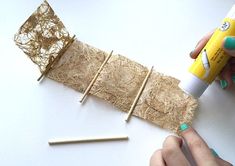 someone is making something out of straw and glue