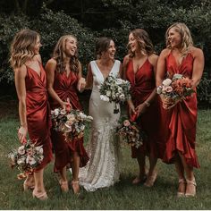 a group of women standing next to each other on top of a lush green field