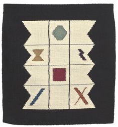 a black and white rug with different colored designs on it's sides, including an arrow