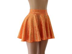 "This skirt features a sparkly gold and neon orange hologram spandex.   SKIRT LENGTHS Length of skirts vary by size below.   Please submit a custom request for lengths not shown.   FRONT/BACK Toddler 2/37\"/8\" Child X-Small        10\" /       11\" Child Small11\"/12\" Child 6X-711\"/12\" Child Medium13\"/14\" Child Large13\"/14\" Adult XS        13\"/14\" Adult Small        15\"     /   16\" Adult Medium15\" /16\" Adult Large16\"/17\" Adult X-Large17\"/18\" Adult 2X        17\"     /   18\" Ad Shiny Fitted Mini Skirt, Fitted Shiny Mini Skirt, Fitted Orange Bottoms For Party, Fitted Orange Mini Skirt, Orange Fitted Mini Skirt, Orange Lined Mini Skirt For Party, Shiny Stretch Mini Skirt Bottoms, Fitted Orange Skort, Orange Mini Skirt For Party