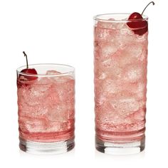 two glasses filled with ice and a cherry on the top one glass is half full