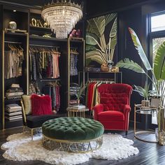 a closet with two red chairs and a green ottoman in front of a chandelier