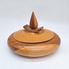 a wooden object is sitting on a white surface