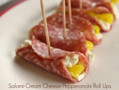 small appetizers are arranged on a plate with toothpicks