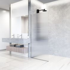 a bathroom with a sink, mirror and shower stall in the middle of the room