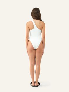 Meet Margot. With its striking asymmetrical neckline and high-cut leg silhouette, this one-piece swimsuit makes a bold statement. One-shoulder Bodysuit With Lined Body, One-shoulder Beachwear Bodysuit For Poolside, Summer Second-skin Swimwear With High-cut Leg, Stretch Bodysuit With Asymmetrical Neckline And Lined Body, Second-skin High-cut Leg Swimwear For Summer, Fitted Bodysuit With Asymmetrical Neckline And Lined Body, One-shoulder Bodysuit For Pool, Chic One-shoulder Bodysuit For Poolside, Stretch One Shoulder Bodysuit For Beachwear