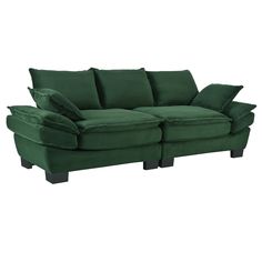 a green couch sitting on top of a white floor