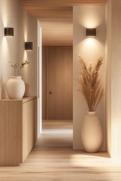 a vase with some plants in it sitting on a shelf next to a light fixture