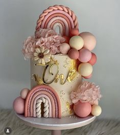 a cake decorated with pink, white and gold decorations