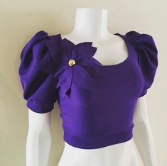 This is not your average crop top honey! This eye catching piece features a scoop neckline, puff sleeves and is finished off with a beautiful hand shaped flower detail  Please view size chart provided before ordering  Available in sizes XS - 3XL Additional colors available! Elegant Puff Sleeve Crop Top For Party, Chic Puff Sleeve Crop Top For Party, Trendy Short Sleeve Crop Top For Parties, Elegant Fitted Crop Top With Puff Sleeves, Chic Purple Crop Top For Party, Fitted Puff Sleeve Crop Top For Party, Trendy Puff Sleeve Crop Top For Night Out, Fitted Cropped Top For Party, Fitted Cropped Crop Top For Party