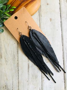 Black Crystal chain leather feather earring/boho leather dangle earring/long leather earring/feather chain earring Boho shabby chic! Black long feather, black crystal chain leather feather dangle earrings.Super light and ready to wear!  Gunmetal Hooks are lead and nickel free .Ready to sell will ship out same or next day in a gift box with tracking:) thanks for looking at my shop:) Adjustable Black Feather Jewelry, Black Feathered Jewelry For Festivals, Trendy Black Earrings For Festivals, Trendy Black Fringe Jewelry, Trendy Black Festival Earrings, Party Leather Dangle Earrings, Elegant Leather Fringe Jewelry, Bohemian Black Feather Earrings, Leather Dangle Jewelry For Party