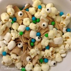 a white bowl filled with popcorn and eyes