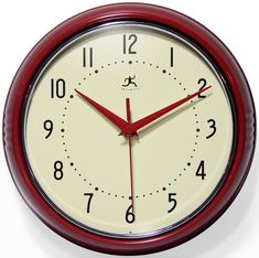 a red and white wall clock with numbers on the face, in front of a white background