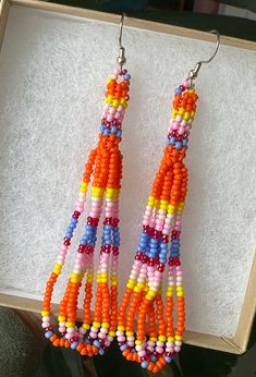 Orange petite stitch beaded earrings. Earrings measure 3 inches.  *made by a local artist* Unique Orange Beaded Earrings, Unique Orange Beaded Earrings With Colorful Beads, Multicolor Beaded Chain Earrings As Gift, Multicolor Beaded Chain Earrings For Gift, Unique Multicolor Beaded Earrings, Orange Beaded Earrings With Tiny Round Beads, Adjustable Orange Tiny Beads Earrings, Indigenous Beaded Earrings, Beaded Jewelry Diy