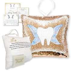 a toothbrush and pillow are sitting next to each other on a white background with gold sequins