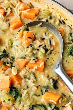 a spoon full of soup with vegetables and rice