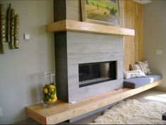 a living room with a fire place in the center and a painting on the wall