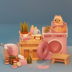 a pink toy washing machine sitting on top of a table next to a potted plant