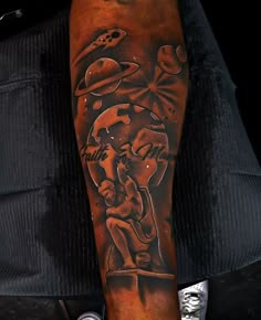 a man with a tattoo on his arm that has an image of a woman holding a baby