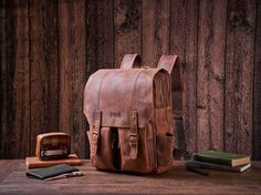 Personalized Daily Backpack, Handmade Full Grain Leather Backpack, Travel Backpack, Laptop Backpack, Men Leather Rucksack, Best Men Gift Personalization We can engrave any picture, initials, name, or logo etc on any location.  Please send picture with Etsy message and leave a note at checkout with what you would like personalized on. Features: 1. Heavy full Grain Leather, about 2.3kg in weight 2. Cotton inside lining,Brass hardware, Magnetic buttons 3. Inside zipper pocket, laptop sleeve,cell po Everyday Carry Backpack With Adjustable Strap, Leather Bag For Outdoor And Back To School, Back To School Leather Outdoor Bag, Leather Bags For Back To School Outdoor Use, Backpack Handmade, Daily Backpack, Everyday Backpack, Backpack Laptop, Leather Rucksack